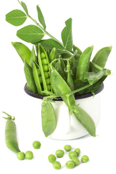 Green young peas in a mug