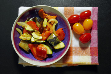 baked vegetables on kitchen cloth with cherry tomato