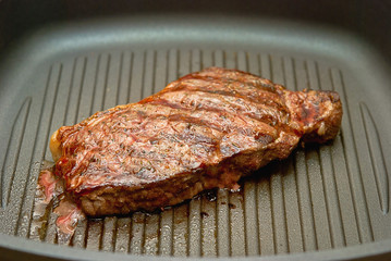 Steak grilled in a frying pan