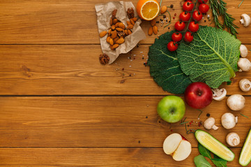 Border of fresh vegetables on wooden background with copy space