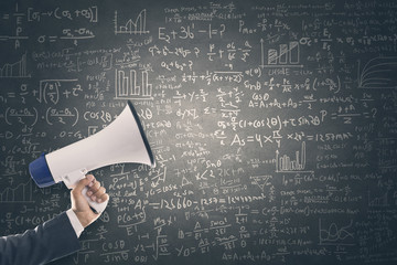 Megaphone with mathematical formula on blackboard
