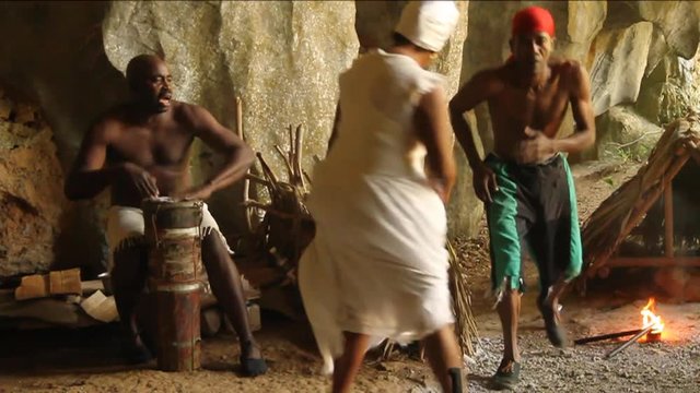 Cuban people dance and drum in cave