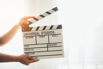 Man hands holding film clapper isolated on white background