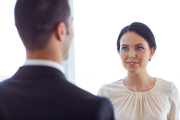 smiling business man and woman at office