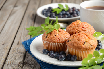 Homemade  blueberry muffins on rustic wooden background, selective focus