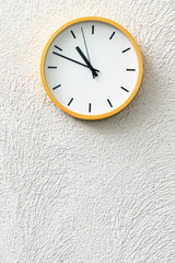 Fototapeta na wymiar Simple analog clock on white wall loft concrete wall