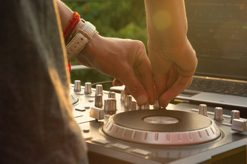 Dj mixing music outdoor.
