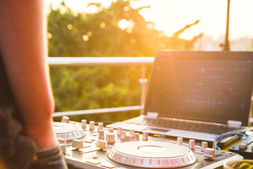 Dj mixing music outdoor.