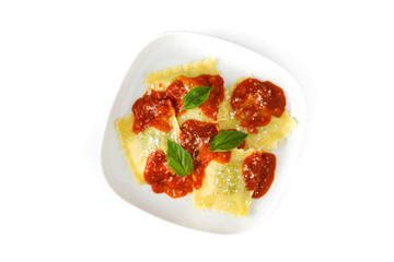 Ravioli with tomato sauce and basil isolated on white background
