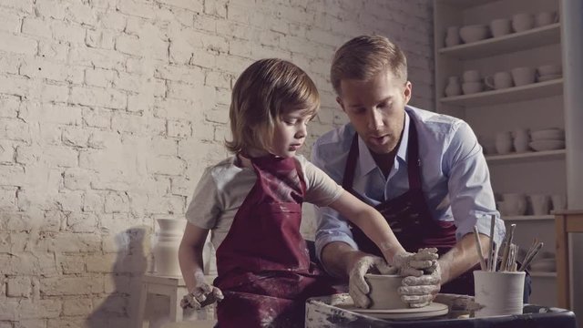 Father and son in a pottery workshop
