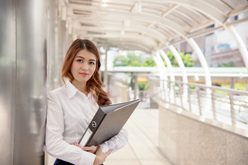 portrait of beautiful businesswoman with folder document at outdoors