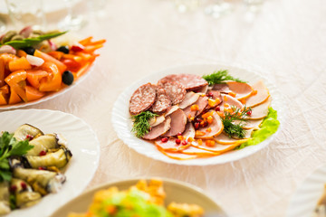 Dish with sliced meat products on the festive table