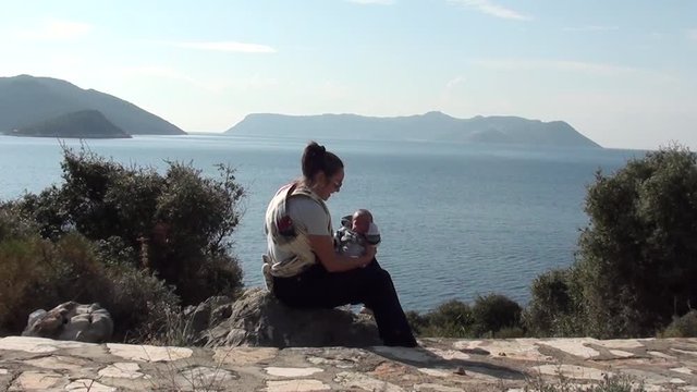 Mother with baby against sea view 