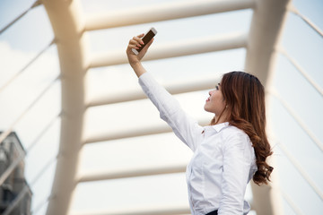 business woman take photo by smart phone camera