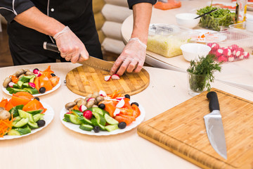 Close-up of chef cooking food kitchen restaurant cutting cook hands hotel man male knife preparation fresh preparing concept
