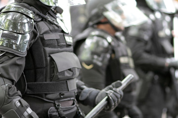 Fototapeta na wymiar Police officers wearing riot gear.