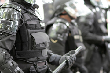 Police officers wearing riot gear.