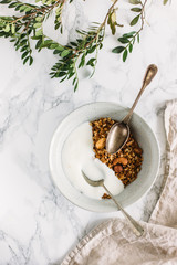 Having breakfast: granola and yogurt. Woman summer concept