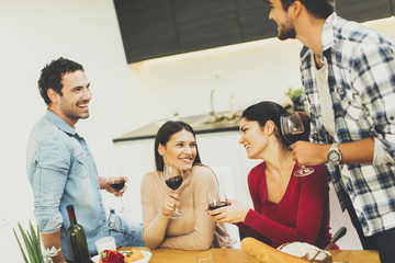 Young people have a meal in the dining room in modern home