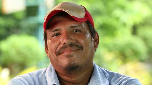 Mexican man puts on hat, close up