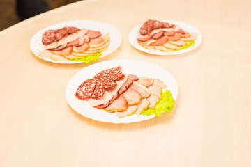 Dish with sliced meat products on the festive table