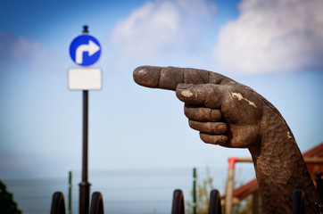 Wooden hand. The index finger indicates the sign of the turn in the opposite direction