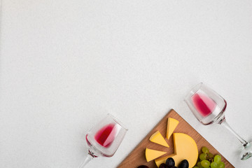 Glasses with red wine on white background from top view