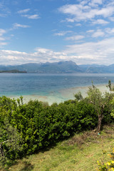 Fototapeta na wymiar Landscape of the coast of Sirmione peninsula which divides the lower part of Lake Garda. It is a famous vacation place for a long time in northern Italy.
