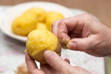 Woman cleaning potatoes with her hands