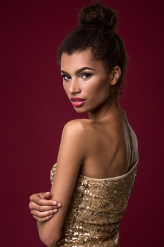 Fashion Young African Woman With Make-up, In Sexy Gold Dress.