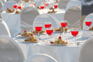 Glasses of wine are on the tables for the banquet