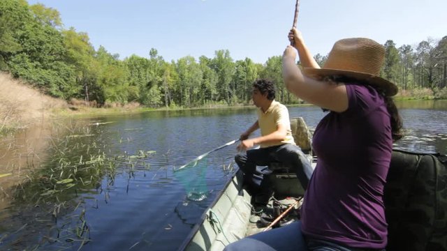 Couple catches freshwater sunfish on lake