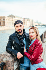 Stylish couple in city . Beautiful couple in love hugging and kissing on street