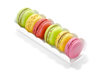 Colorful macaroons in a gift box on white background.