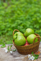 Fresh sweet juicy red green apples flowers on wood