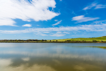 Platamona pond under a cloudy sky in springtime