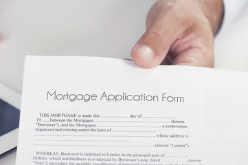 Male hand presents a mortgage document