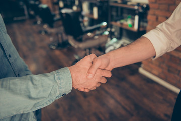 Friendship, trust, men`s life, barber shop concept. Two guys - worker of salon and a client became...