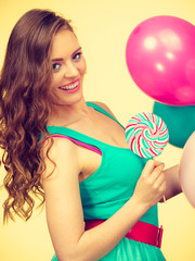 Woman with colorful balloons and lollipop