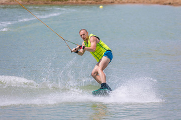 Man study wakeboarding on a blue lake