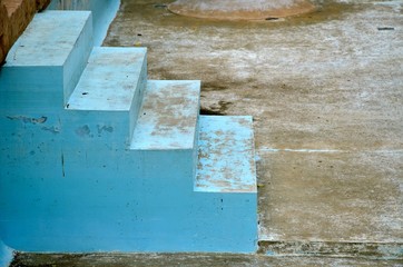 Side view to the concrete blue vintage stairs and brown vintage floor. Symbol of the future. Horizontal patina photo.