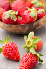 Strawberry in a bowl on the gray background.