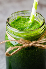 Spinach smoothie, on the grey  background.