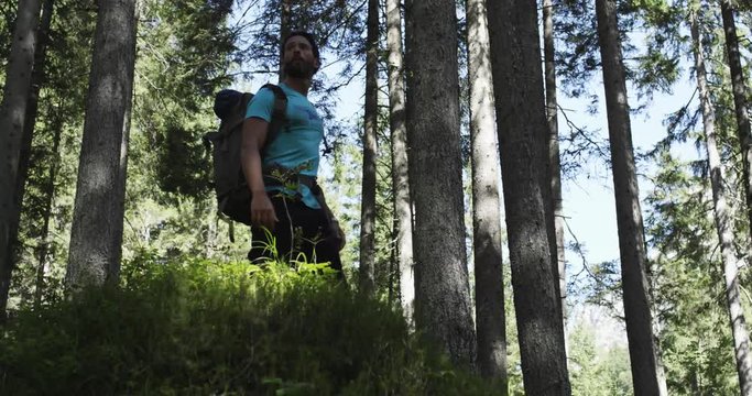 Woman photographer shooting photos with man friend in sunny forest.Group of friends summer adventure journey in mountain nature outdoors.Travel exploring Alps,Dolomites,Italy.4k slow motion 60p