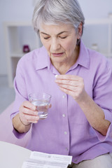 Senior woman taking medicine