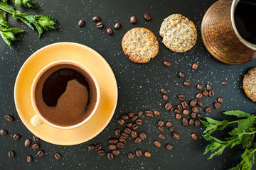 Coffee in yellow cup on black background.