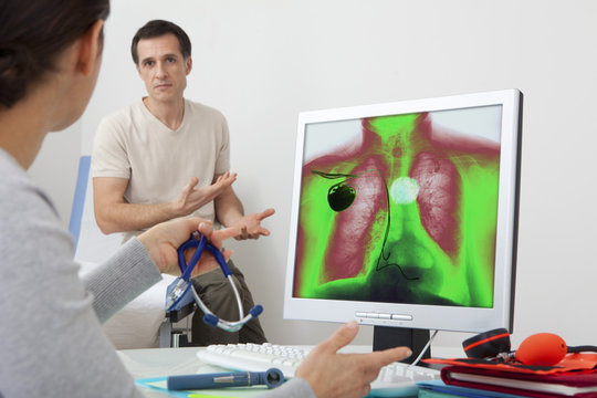 Models On screen, colorized x-ray of a patient carrying a pacemaker, and affected by a hiatal hernia