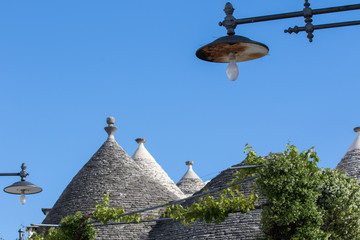 Alberobello, Italy - May 25, 2017: Trulli stone roof of the Apulian village, with the sky background