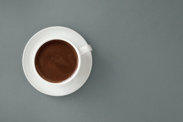 Coffee in white cup on gray background.