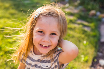 Portrait of sweet little girl play outdoors